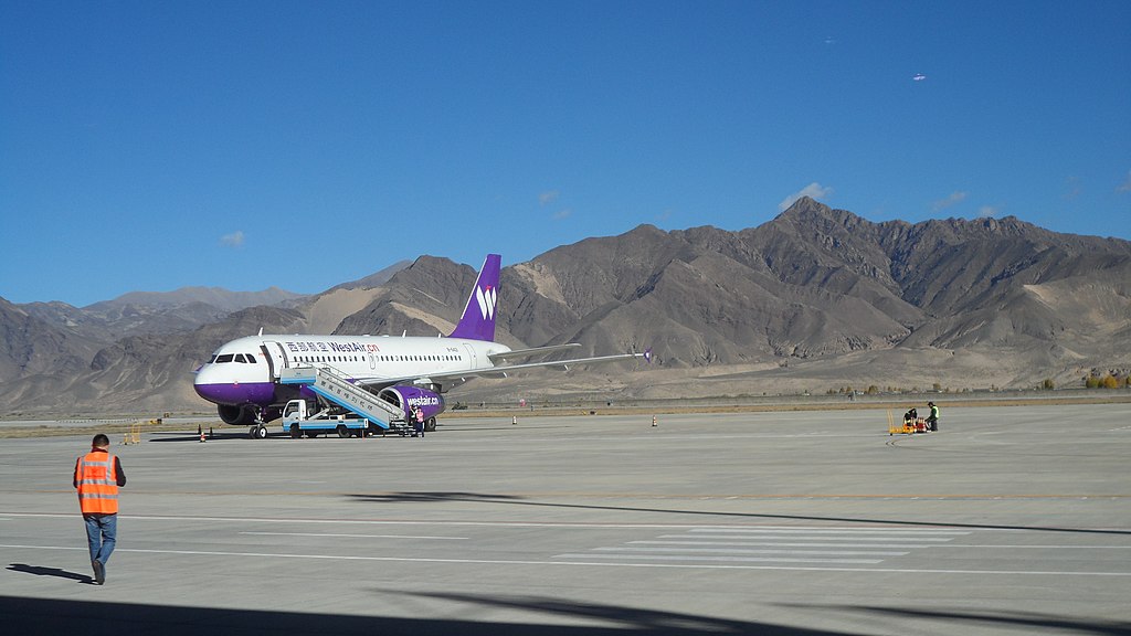 The airplane is being serviced at the shigatse peace airport